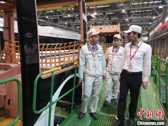 Rafiq Khan and his colleagues work in the assembly shop of Urban Rail Business Department, CRRC Zhuzhou Locomotive CO., LTD. [Photo/ Liu Man]